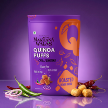 A purple bag of Makhana Walas Quinoa Puffs (Chilli Chataka) is shown on a reflective purple surface with green chilies, red chilies, onion rings, and roasted puffs as props.