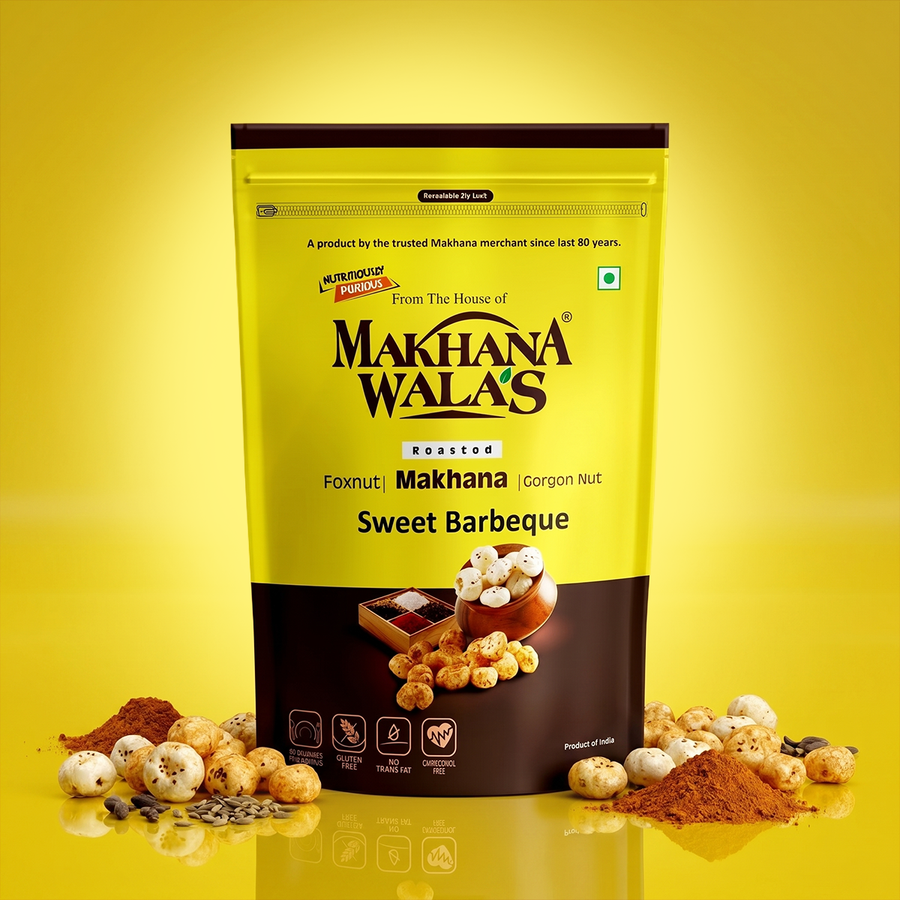 A stand-up pouch of Makhana Wala's Roasted Sweet Barbeque foxnut makhana, set against a bright yellow background with scattered makhana and spices at the base.